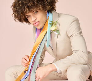Young man modelling a cream coloured suit set
