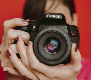 Person holding Canon camera